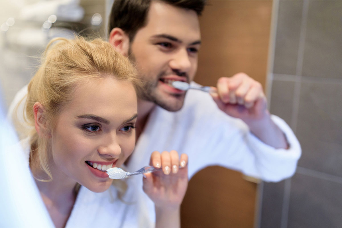 Couple brush their teeth
