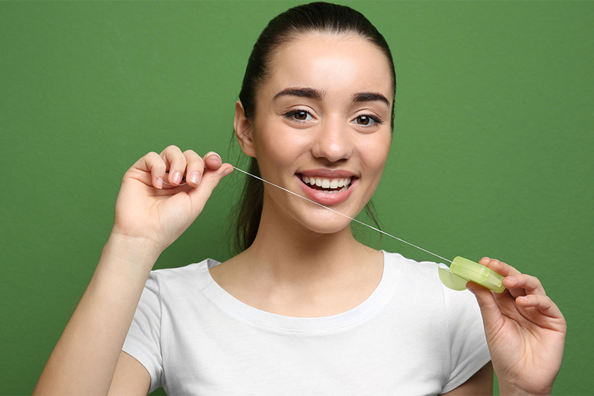 Beautiful woman flossing